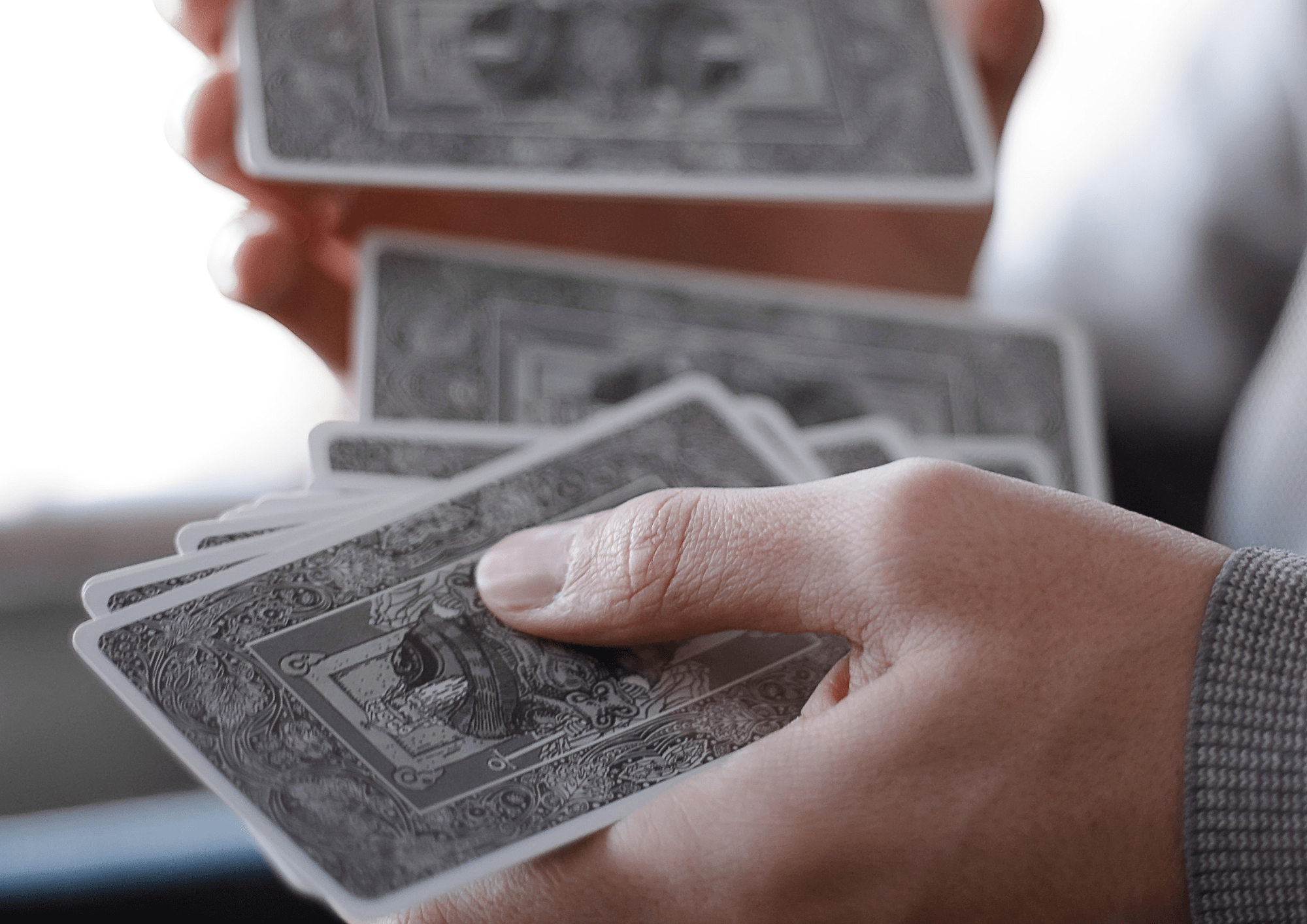 Persona sosteniendo unas cartas del tarot mientras mezcla las cartas del tarot